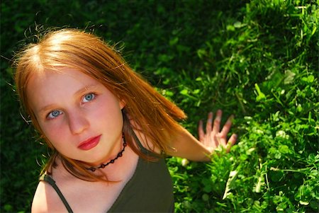 preteen beautiful face - Young pretty girl sitting on green grass outside Stock Photo - Budget Royalty-Free & Subscription, Code: 400-04937975