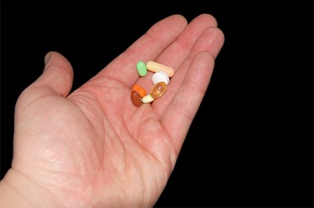 Drugs in hand isolated on black background Stock Photo - Budget Royalty-Free & Subscription, Code: 400-04938313