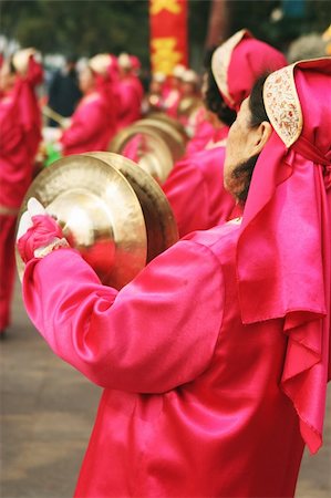 Chinese New Year celebrations in Qingdao, China - a woman plays a musical instrument on the second day of the week-long vacation. Stock Photo - Budget Royalty-Free & Subscription, Code: 400-04938888