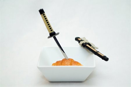 sushi dessert - katana cutting a croisant isolated on white background Stock Photo - Budget Royalty-Free & Subscription, Code: 400-04938932