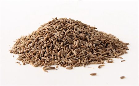 simsearch:400-06559340,k - whole cumin seeds, isolated on white. Shallow depth of field, focused on the centre of the pile. Stock Photo - Budget Royalty-Free & Subscription, Code: 400-04939226