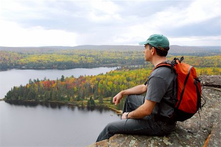 A hiker sitting on a cliff edge enjoying scenic view Stock Photo - Budget Royalty-Free & Subscription, Code: 400-04939629