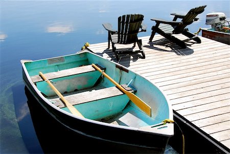 simsearch:400-03929357,k - Two wooden adirondack chairs on a boat dock on a beautiful still lake with sky reflection Foto de stock - Super Valor sin royalties y Suscripción, Código: 400-04939622
