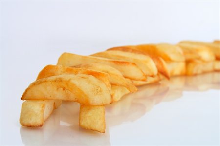 french lifestyle and culture - A close-up shot of composition of fries or traditional English chips oven baked with focus on the front Stock Photo - Budget Royalty-Free & Subscription, Code: 400-04939697