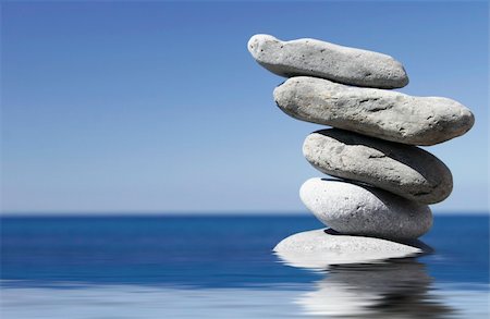 simsearch:400-07772579,k - Stack of pebbles in shallow water with blue sky background Fotografie stock - Microstock e Abbonamento, Codice: 400-04939812