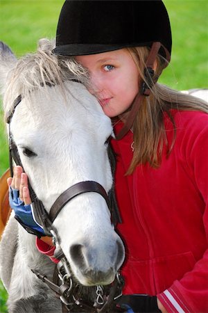 Portrait of a young girl with a white pony Foto de stock - Super Valor sin royalties y Suscripción, Código: 400-04939942