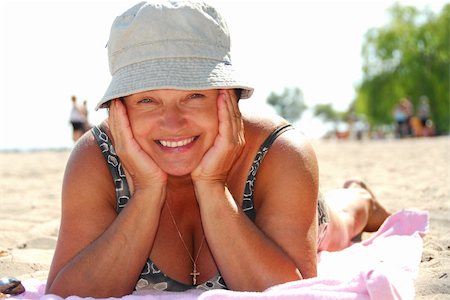 Mature woman lying on a sandy beach Stock Photo - Budget Royalty-Free & Subscription, Code: 400-04939967