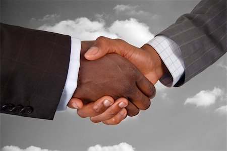 simsearch:400-03956950,k - This is an image of two business hands performing a handshake, with a cloud background. Foto de stock - Royalty-Free Super Valor e Assinatura, Número: 400-04932218