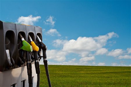 Three gas pump nozzles over a nature background Stock Photo - Budget Royalty-Free & Subscription, Code: 400-04933083