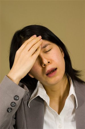 Woman with hand on forehead. Headache, thinking, regretting... anything! Stock Photo - Budget Royalty-Free & Subscription, Code: 400-04933956