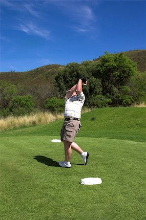 simsearch:400-03912170,k - Golfer finishing the shot on the tee box. Golf club is out of focus, because it is still moving. Foto de stock - Super Valor sin royalties y Suscripción, Código: 400-04944335