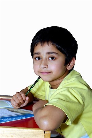 simsearch:400-04434314,k - A kindergarden kid doing homework agains a white background Photographie de stock - Aubaine LD & Abonnement, Code: 400-04944793