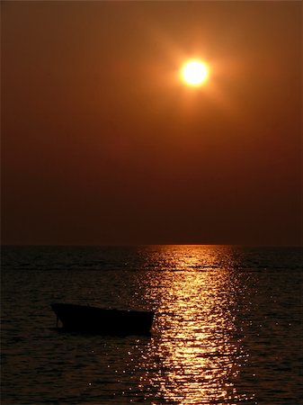portrait of beautiful sunset beside smal boat Fotografie stock - Microstock e Abbonamento, Codice: 400-04944858