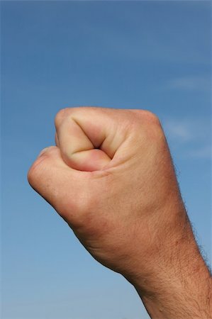 simsearch:400-04790437,k - Clenched fist of a man against a blue sky. Stock Photo - Budget Royalty-Free & Subscription, Code: 400-04945152