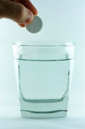 fizzing effervescent tablet - A hand dropping aspirin tablet into glass with water. Stock Photo - Budget Royalty-Free & Subscription, Code: 400-04945325