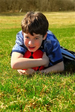 Portrait of a young boy with a red soccer ball outside Stock Photo - Budget Royalty-Free & Subscription, Code: 400-04945445
