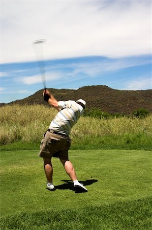 simsearch:400-03912170,k - Sexy golfer with trained culfs hitting the ball from the tee box. Golf club is in motion. Foto de stock - Super Valor sin royalties y Suscripción, Código: 400-04945935