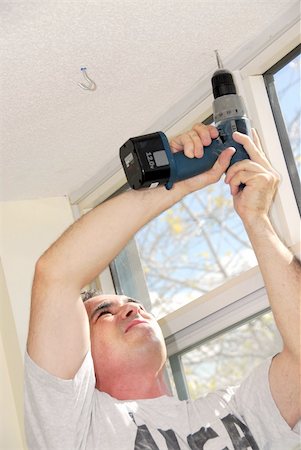 Man drilling a hole in a ceiling Stock Photo - Budget Royalty-Free & Subscription, Code: 400-04946166