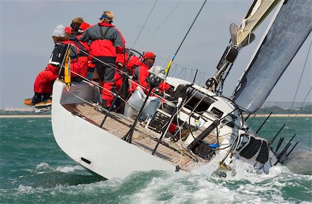 A fully crewed racing yacht racing hard and leaving a big wake Stock Photo - Budget Royalty-Free & Subscription, Code: 400-04946980