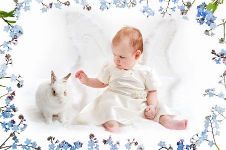 cute little girl dressed like fairy with fluffy wings plays with white rabbit, with beautiful flower ornament Stock Photo - Budget Royalty-Free & Subscription, Code: 400-04947160