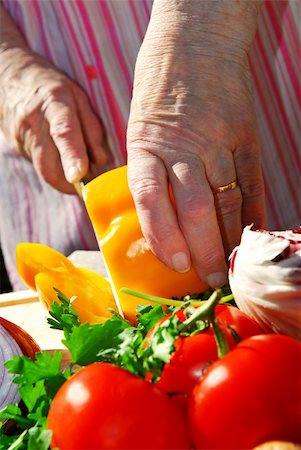 Hands of an elderly woman cutting fresh vegetables Stock Photo - Budget Royalty-Free & Subscription, Code: 400-04947595