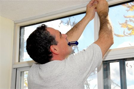 Man installing window blinds in a house Stock Photo - Budget Royalty-Free & Subscription, Code: 400-04947599