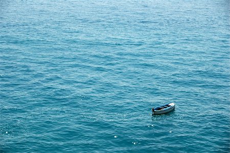 spartika (artist) - A lone boat sits empty in the middle of the sea. Stock Photo - Budget Royalty-Free & Subscription, Code: 400-04948955