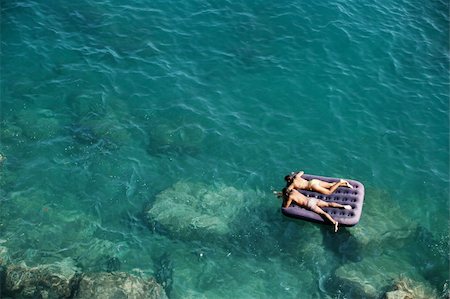 spartika (artist) - A man and a woman float on an inflatable mattress in the blue green mediterranean sea. Stock Photo - Budget Royalty-Free & Subscription, Code: 400-04948958