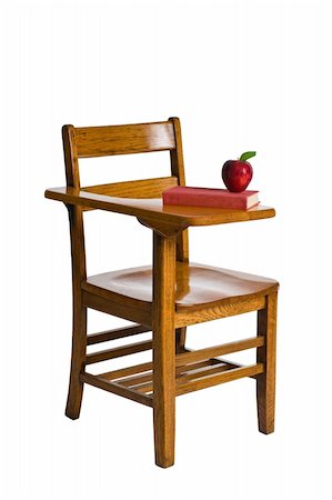 A wooden school desk with a red book and an apple. Isolated on white. Foto de stock - Royalty-Free Super Valor e Assinatura, Número: 400-04949364