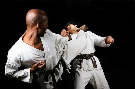 simsearch:400-03922328,k - African American versus Caucasian karate fight(kumite) hayashi ha style, black and brown belt, sport series Photographie de stock - Aubaine LD & Abonnement, Code: 400-04949615