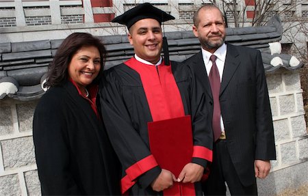 people successful college graduate with family - Happy graduate with his mother and father. Stock Photo - Budget Royalty-Free & Subscription, Code: 400-04940578