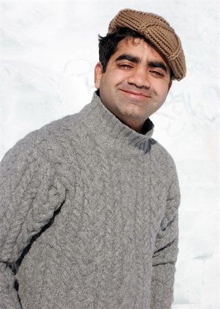 snow cosy - Smiling Indian man in winter clothing (background is snow). Stock Photo - Budget Royalty-Free & Subscription, Code: 400-04940688