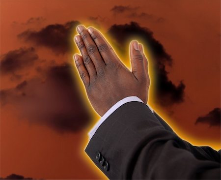 This is an image of businessman with hands in a prayer posture. This is image can be used to represent "Prayer Of Fire" themes. The yellow/orange glow round the fingers represent fire. Stock Photo - Budget Royalty-Free & Subscription, Code: 400-04940698