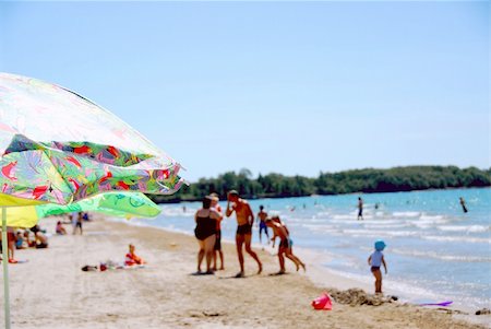 sunbathing crowd - Crowded beach shallow dof, focused on the umbrellas in the front Stock Photo - Budget Royalty-Free & Subscription, Code: 400-04940790