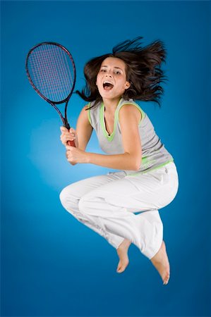 happy woman with tennis racket on the blue background Stock Photo - Budget Royalty-Free & Subscription, Code: 400-04940924