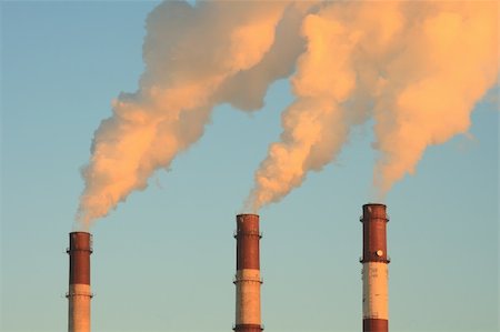 Three smoking chimneys lit by setting sun, against clear sky Stock Photo - Budget Royalty-Free & Subscription, Code: 400-04941585