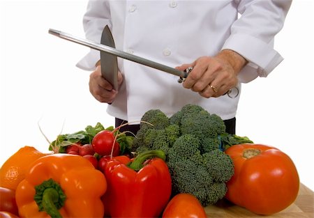 Professional chef sharpening knife inlcluding assorted fresh vegetables Stock Photo - Budget Royalty-Free & Subscription, Code: 400-04941862