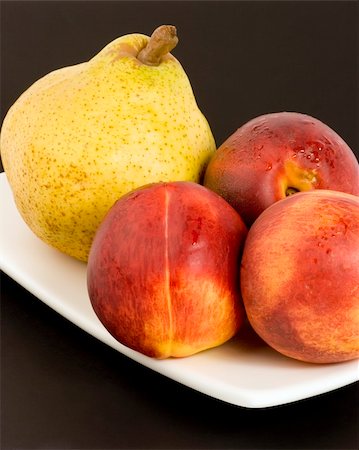 simsearch:400-04433511,k - Necterines and a pear set against a plain background Stock Photo - Budget Royalty-Free & Subscription, Code: 400-04942057