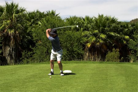 simsearch:400-03912170,k - Golfer hitting the ball from the tee box. Golf club is in motion. Foto de stock - Super Valor sin royalties y Suscripción, Código: 400-04942115