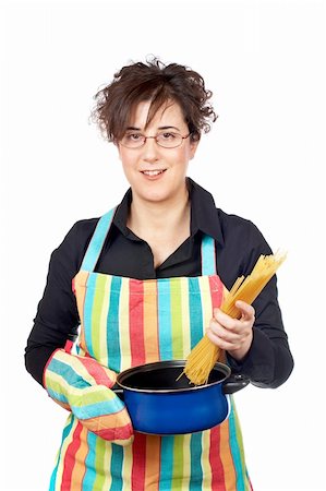 Housewife in apron who introduces a spaghetti uncooked in the blue pan Stock Photo - Budget Royalty-Free & Subscription, Code: 400-04942326