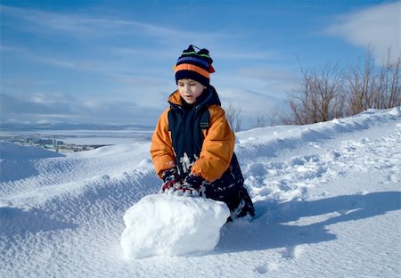 Portrait of the boy with a snowball on a background of polar mountains Stock Photo - Budget Royalty-Free & Subscription, Code: 400-04942461