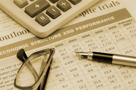 pen, calculator and glasses on the table "Economic structure and perfomance", made with sepia tones Stock Photo - Budget Royalty-Free & Subscription, Code: 400-04942535