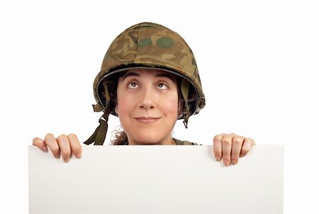 Curious soldier girl holding advertising space looking up Stock Photo - Budget Royalty-Free & Subscription, Code: 400-04942726