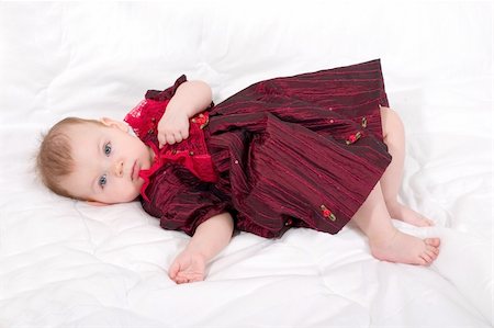 cute little girl in the formal wear lying on the white bed Photographie de stock - Aubaine LD & Abonnement, Code: 400-04943548