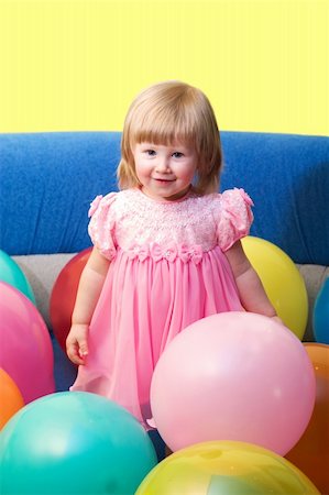 portrait of cute little girl with balloons, with copy space on top Foto de stock - Super Valor sin royalties y Suscripción, Código: 400-04943661