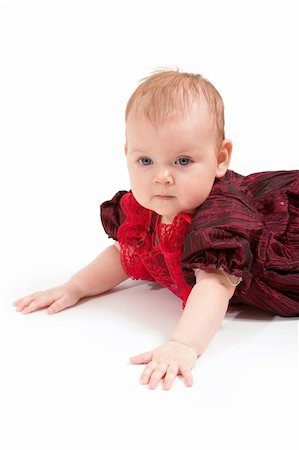Little baby girl in formal red dress. Copy space is on the left top. Foto de stock - Super Valor sin royalties y Suscripción, Código: 400-04943673