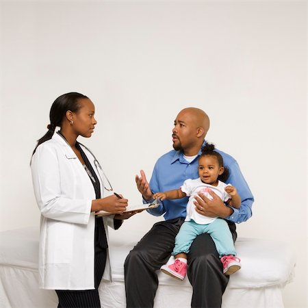 African-American father holding baby girl talking to female pediatrician. Stock Photo - Budget Royalty-Free & Subscription, Code: 400-04954758