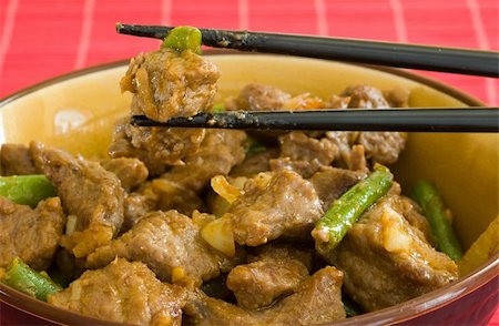 asian food of beef and vegetables on brown bowl and black chopstick Stock Photo - Budget Royalty-Free & Subscription, Code: 400-04954944