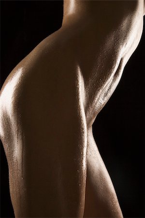 simsearch:400-04956678,k - Side view of thighs and stomach of nude Hispanic mid adult woman glistening with body oil. Foto de stock - Super Valor sin royalties y Suscripción, Código: 400-04955629