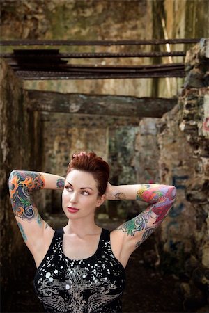 Sexy tattooed Caucasian woman standing next to concrete wall. Stock Photo - Budget Royalty-Free & Subscription, Code: 400-04955704